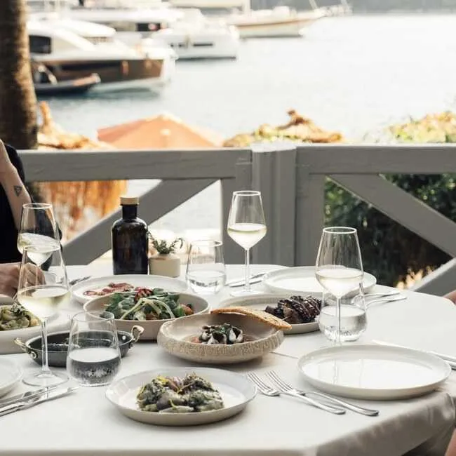 Yaz tatilinde resort otel Marina Martı Yacht Club restoranda masa düzenini gösteren görsel.